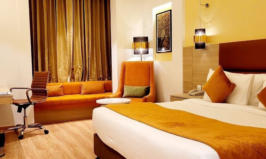 room with a king size bed and wooden flooring at best western vrindavan
