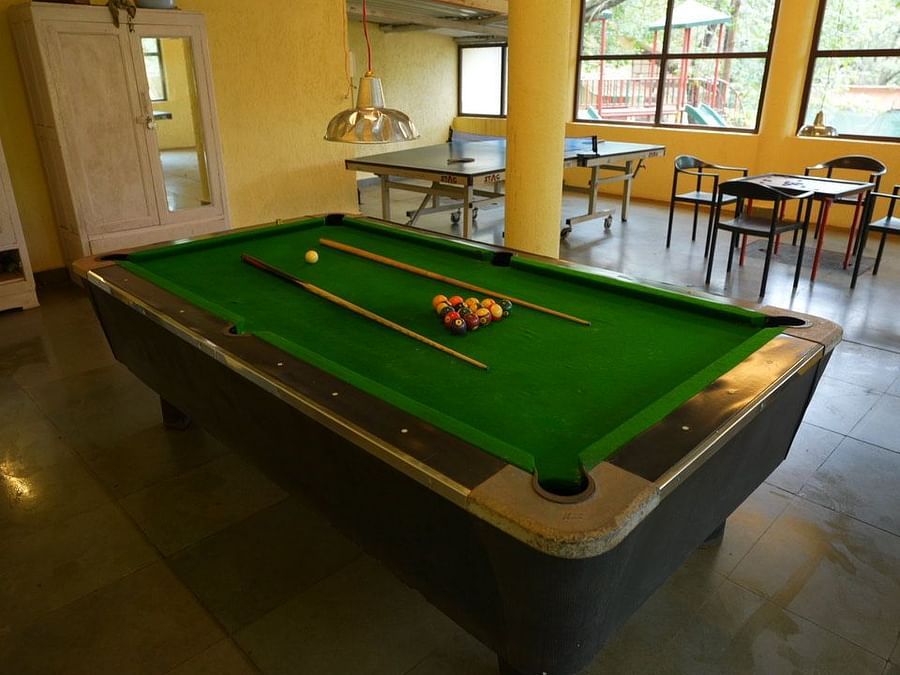 Adamo the Village Game Room with a snooker table and seating space in the background.