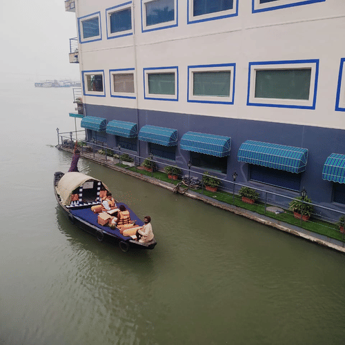 a boat passing by Polo Floatel - the floating hotel in kolkata