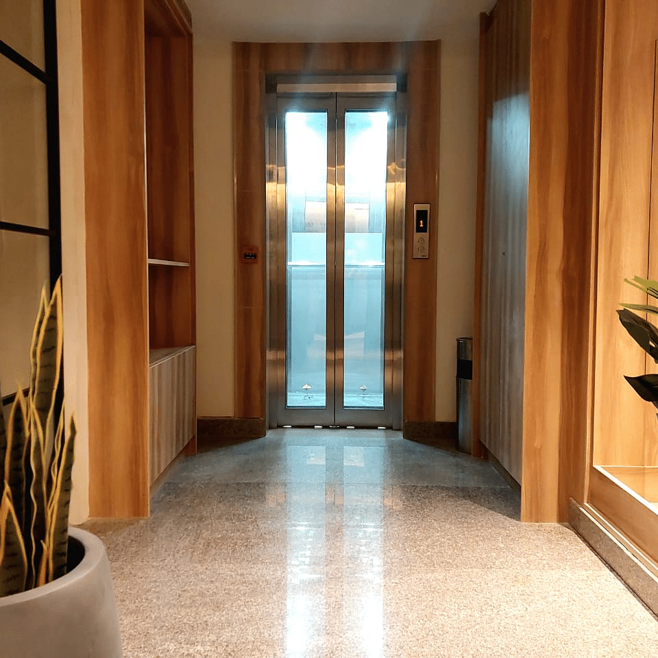 Image of a lift area with plants on the side at Hotel Raai