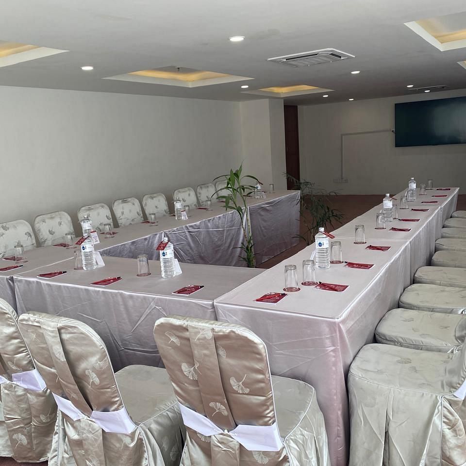 A banquet hall, windows with curtains and TV