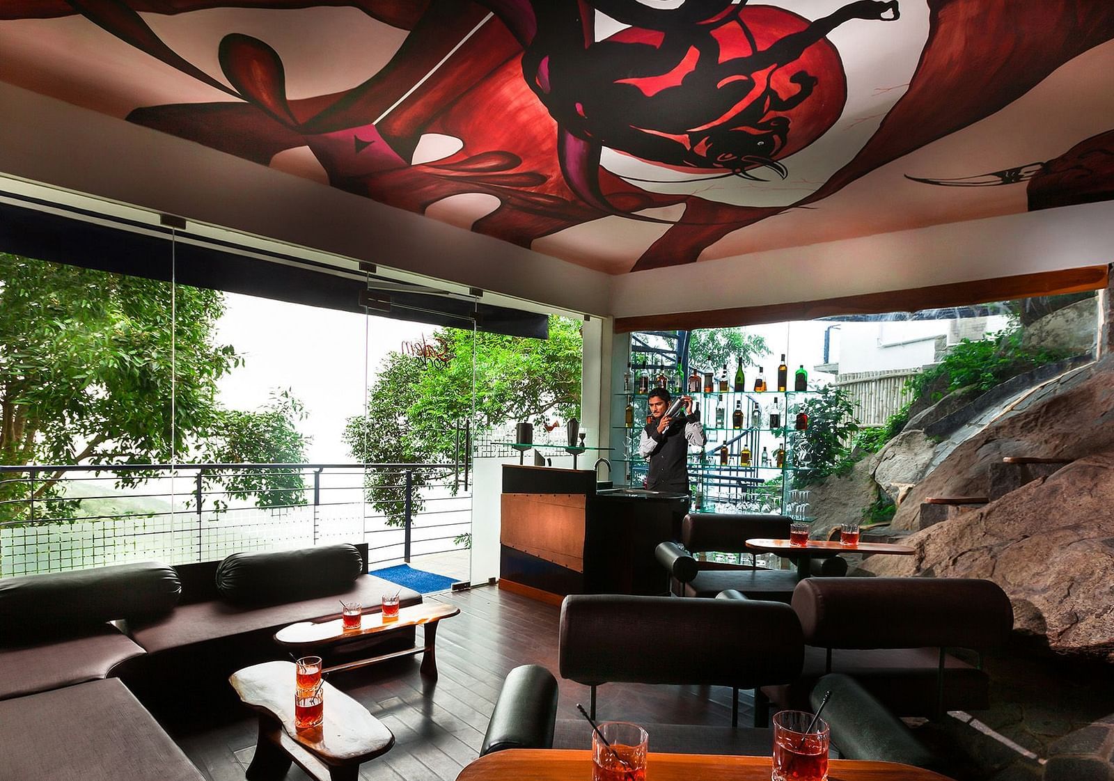 An image of a room with a sofa and table and a bar counter