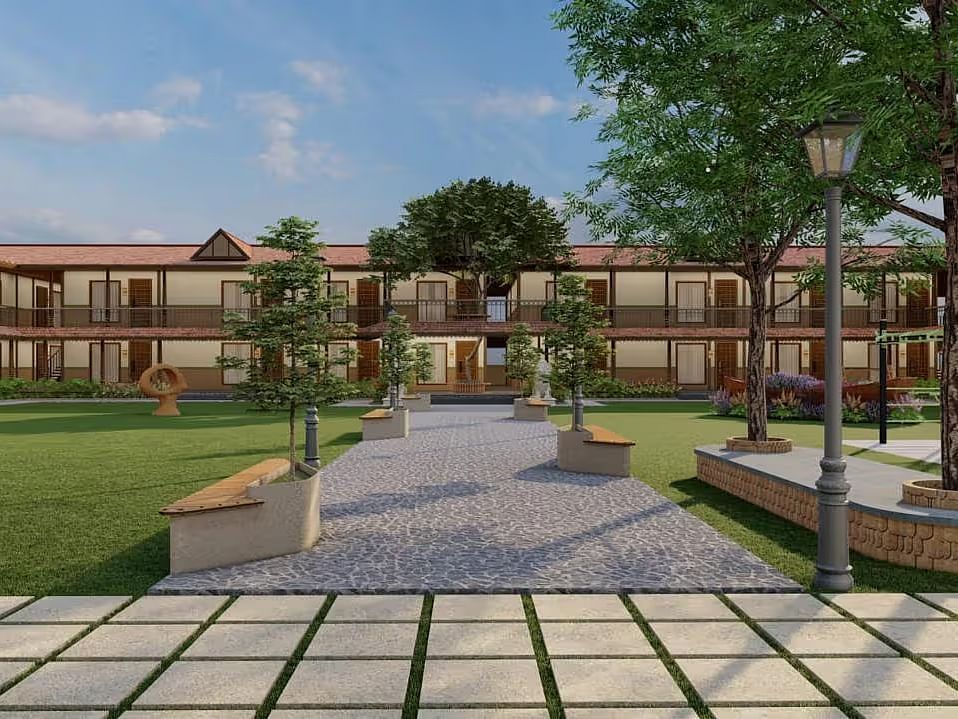 A resort with a two-storey building and green lawns in front, under a partly cloudy sky | Ayana Resorts & Convention, Hyderabad