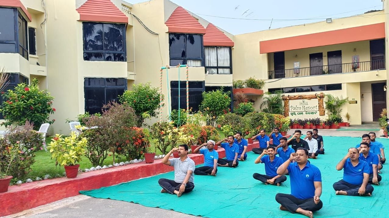 People practising yoga at Swosti Resorts on a sunny day