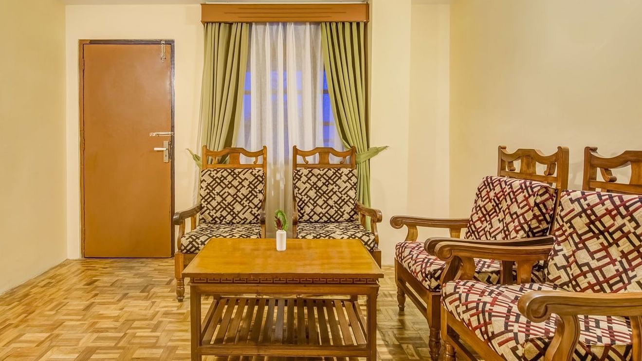 Image of a room with chiars and wooden table at Summit Tashi Ghang Heritage Resort, Pelling