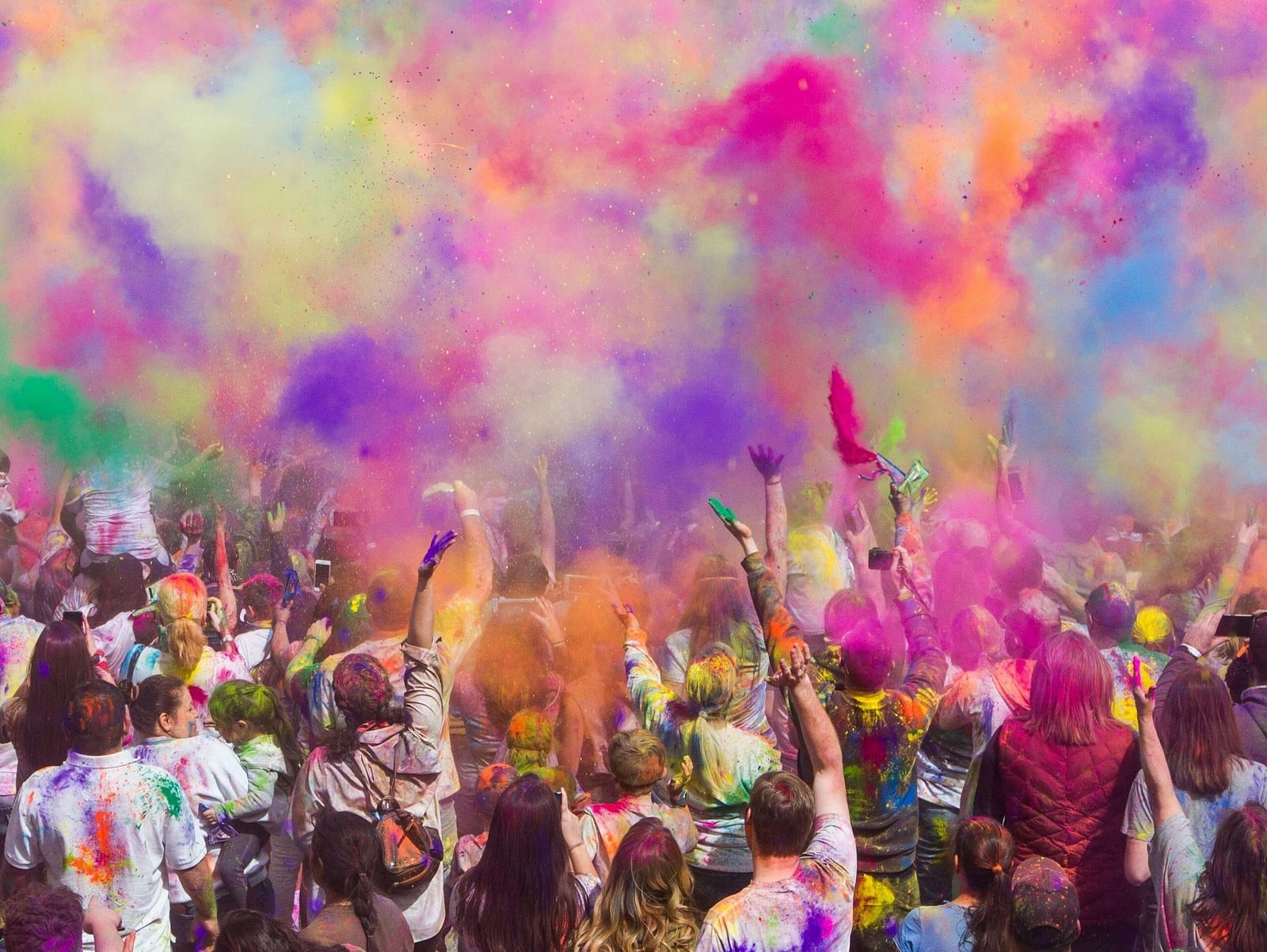 A colourful picture where a group people can be seen playing with colours on holi festival.