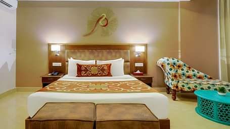 Image of a room wit bed and and sitting area at Summit By The Ganges Beach Resort & Spa, Rishikesh