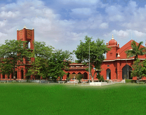 Image of a wide building with lawn area in the front, captured in the day light