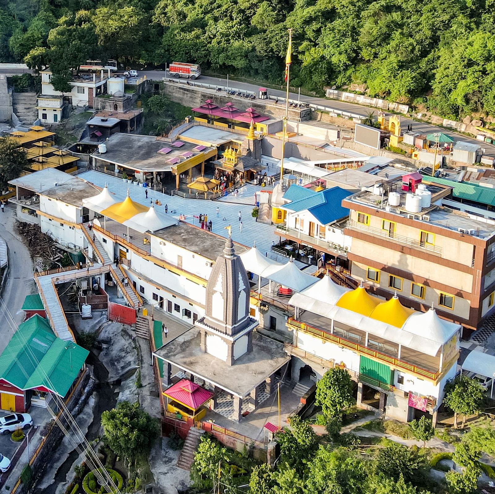 An image of our hotel building with vibrant mountains surrounding it - NAMAMI BY ZENQ BANKHANDI