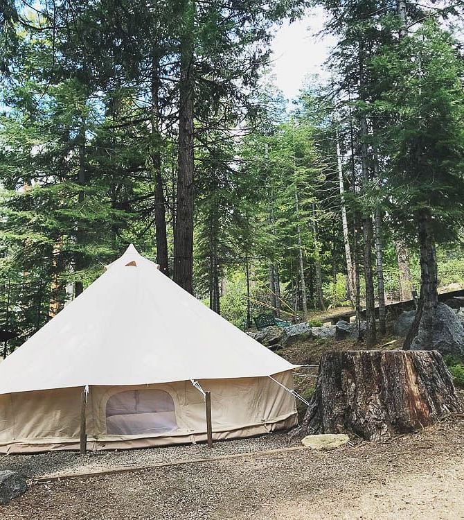 Exterior of a tent at Shaver Lake Village Hotel surrounded by trees.