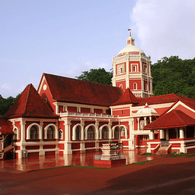 facade view of Shree Shantadurga Temple Kavlem with trees in the background