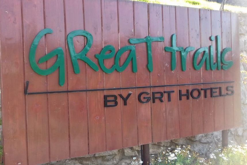 A wooden signboard of GReaT trails Kodaikanal by GRT Hotels