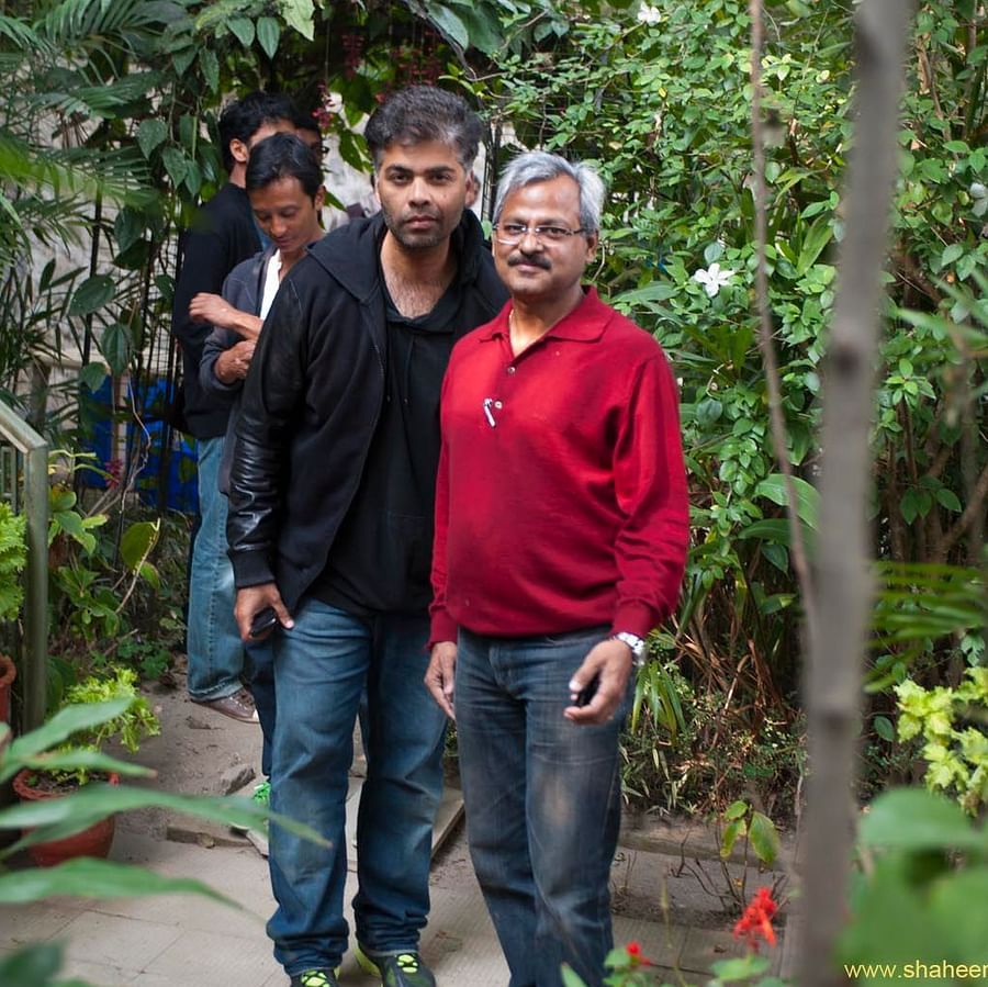  Image of  two people posing for a picture with greenery behind them 