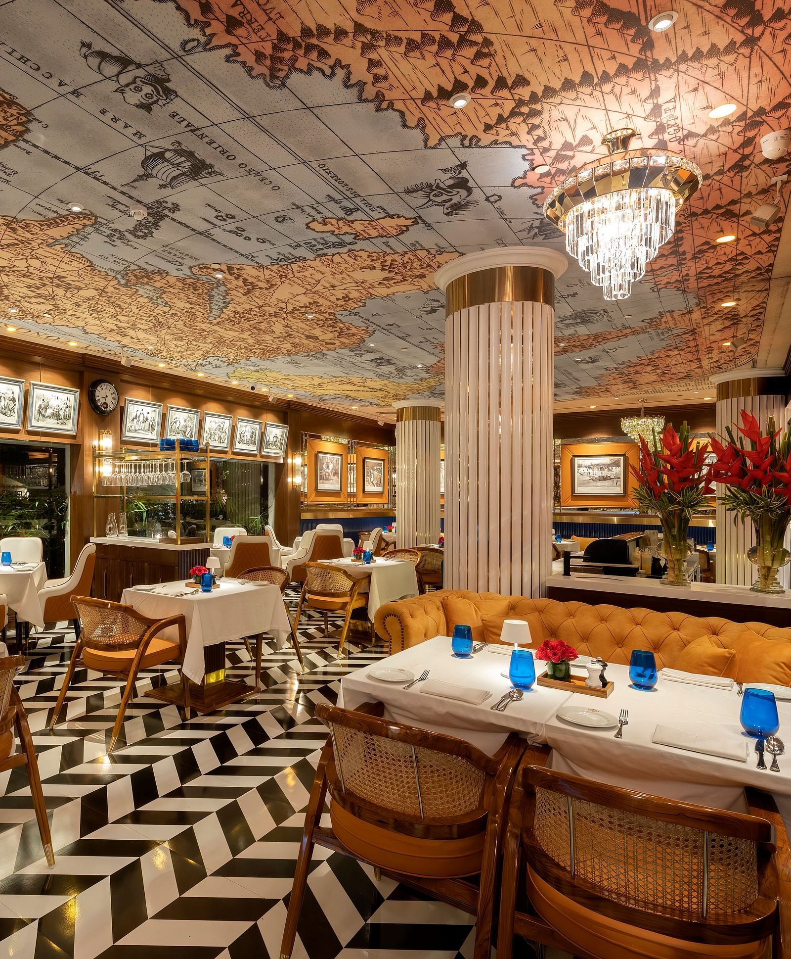 image of the pickwick multi cuisine restaurant in delhi with stunning interiors and a ceiling with a world map - The Claridges New Delhi