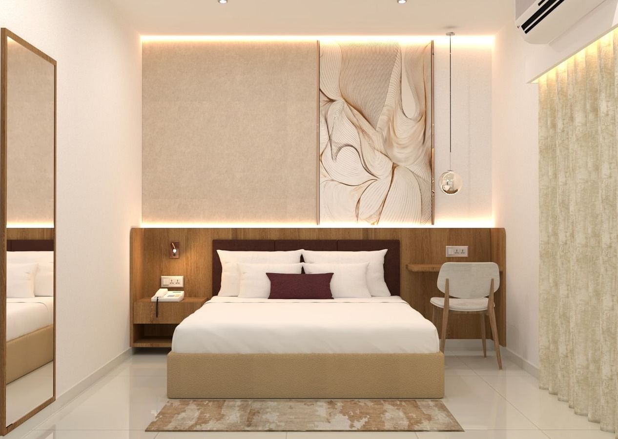 A double bed with side tables and lamps inside one of the rooms - TGI Livancia The Sojourn, Bangalore