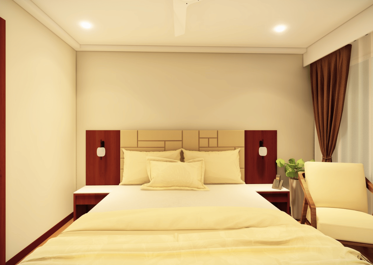 A room with a large bed, 2 small side tables with lamps, an armchair, and a mix of white transparent curtains and dark brown curtains by the windows at Palolem Beach Resort, Goa.