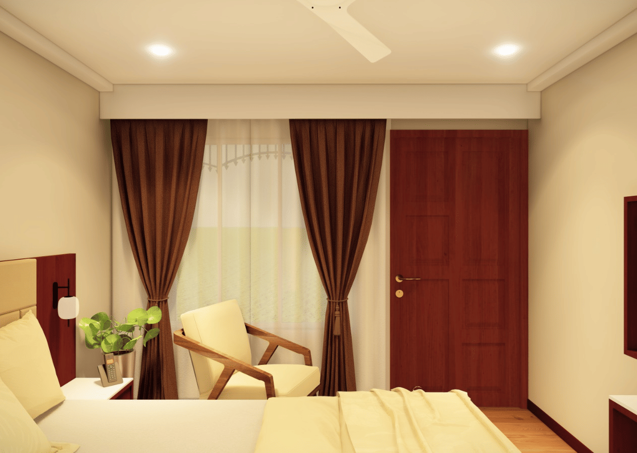 A room with a large bed, a armchair, a television, and dark brown curtains framing the window at Palolem Beach Resort, Goa.