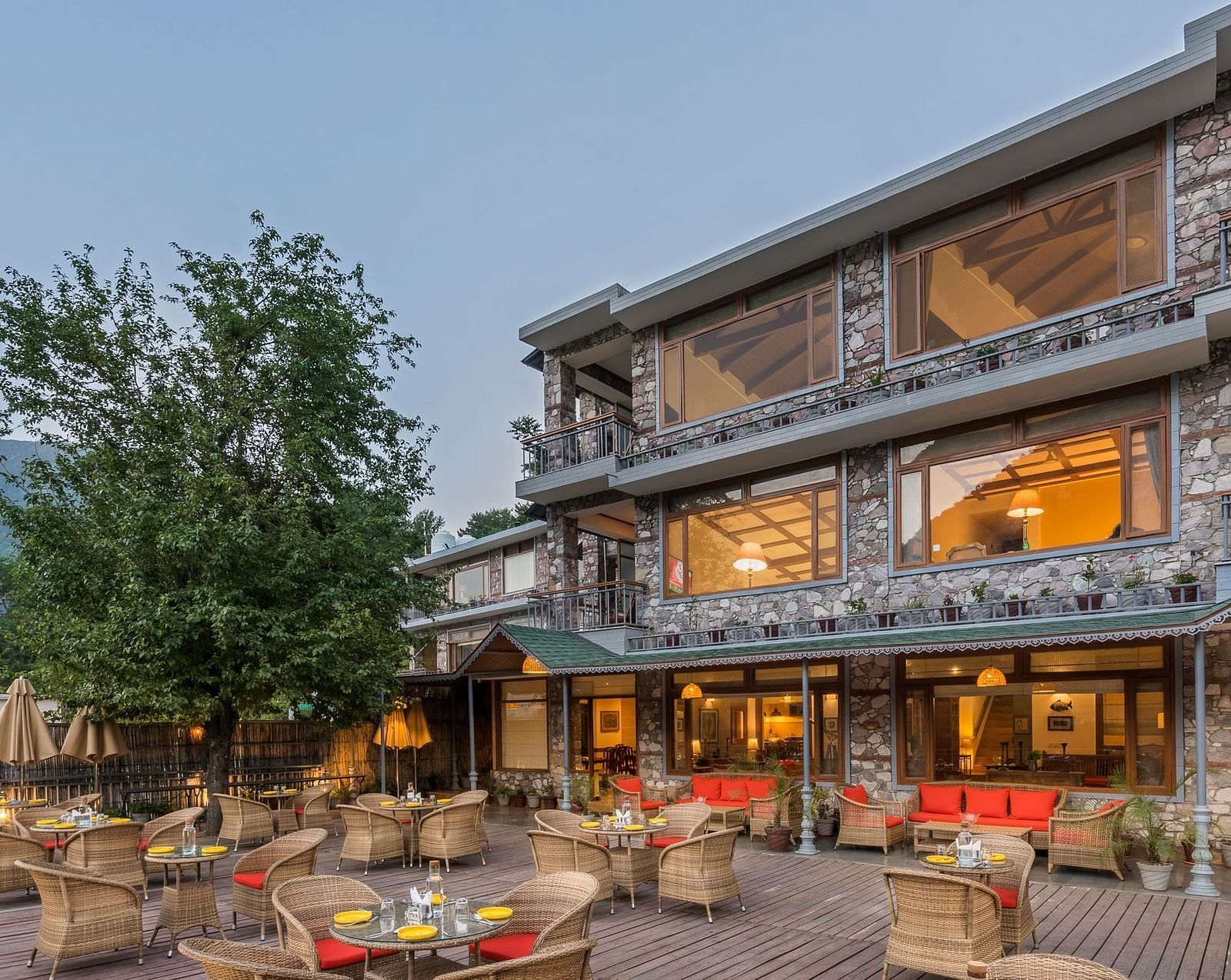 Outdoor restaurant at Fishermen's Lodge, Bhimtal, featuring a beautiful view, creating a perfect setting for dining in nature.