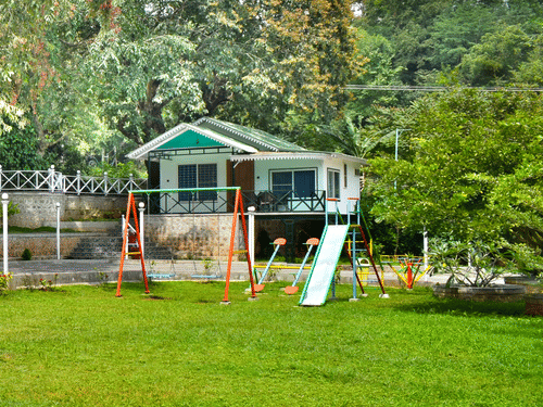 Image of the Play area featuring the swing and slider in the day time.