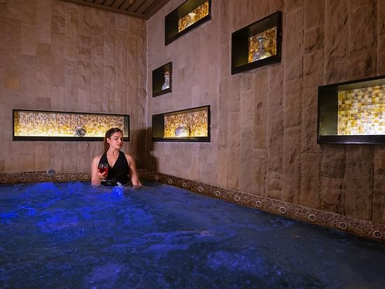 An image of a women inside a bathing tub -  The Manor Luxury Hotel, Shimla