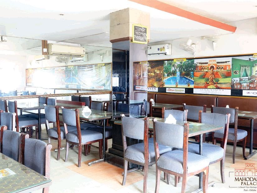 Indoor view of Vithal Kamat family restaurant with dining tables and chairs arranged for guests