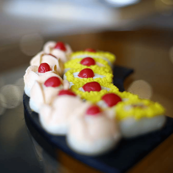 A plate containing cream with cherries | The Bristol Hotel