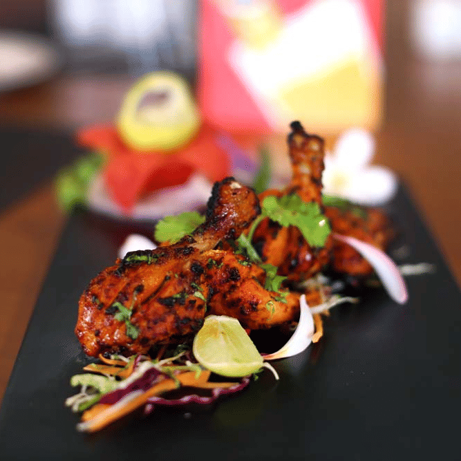 A plate containing barbeque with vegetables | The Bristol Hotel