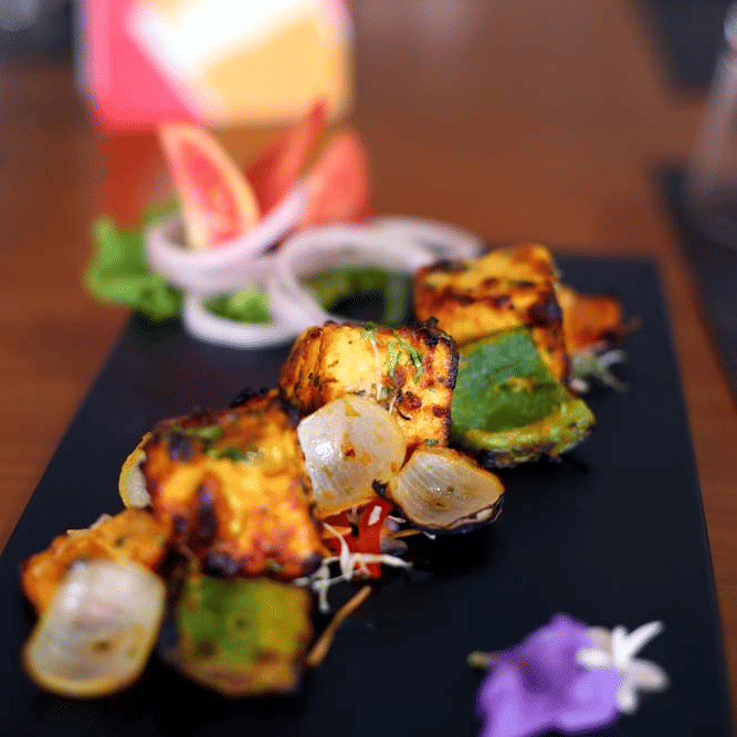 A plate containing barbeque with vegetables | The Bristol Hotel