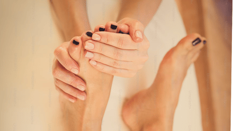 A technician giving foot massage to its client.