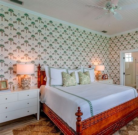 Bedroom with a bed, patterned wallpaper, and soft lighting | Abaco Inn