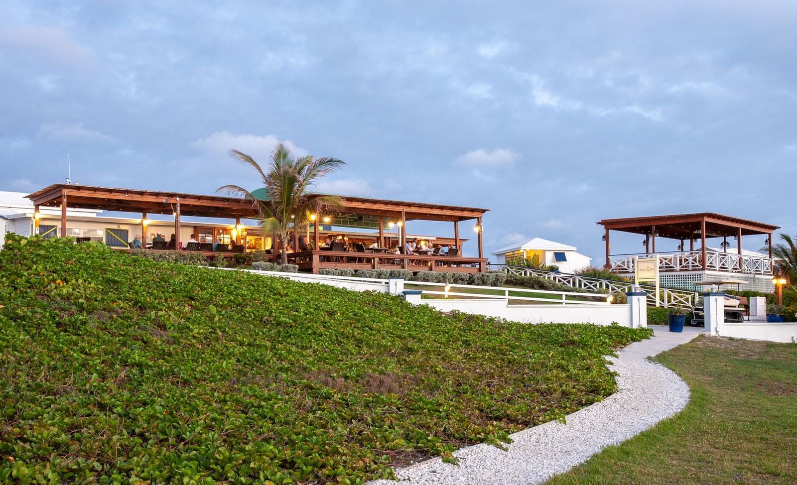 Pathway leading to pavilions on green lawn | Abaco Inn