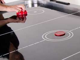 people playing air hockey - Buena Vista Luxury Garden Spa Resort