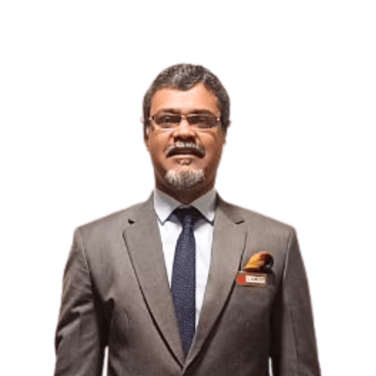 Mr. Clement wearing a suit and tie standing against a plain background - Lords Hotels & Resorts