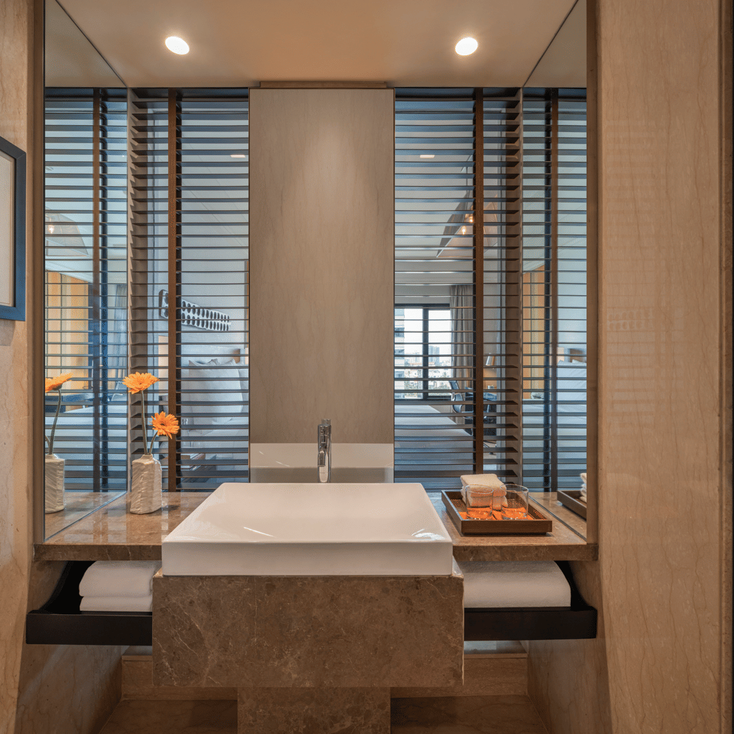 Guest room with bed, desk, and window view at The Raintree, St. Mary’s Road.