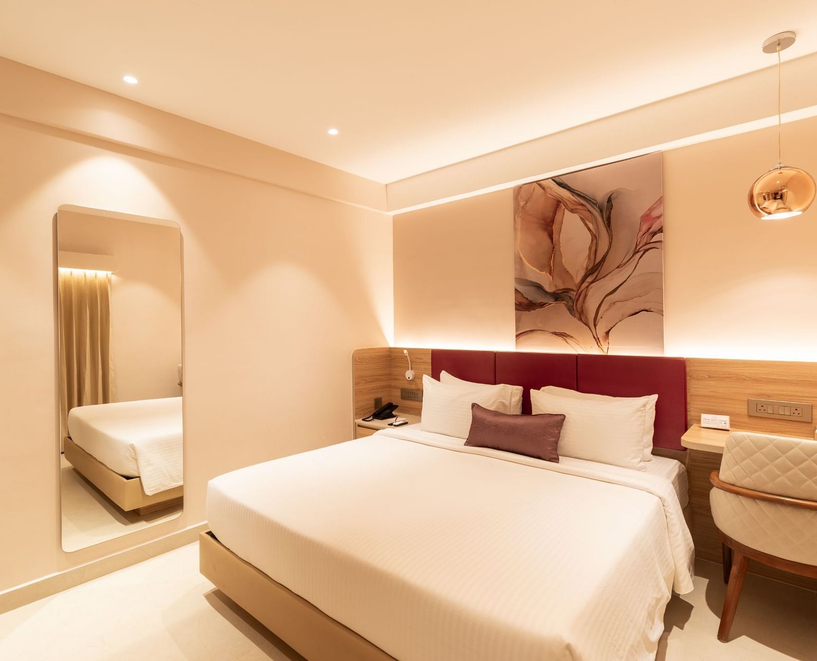Comfortable bed setup in The Premium Rooms at TGI Livancia The Sojourn, Bangalore.