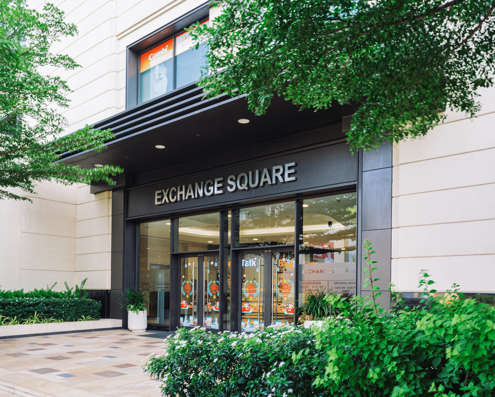 Modern entrance of Exchange Square mall, a premier shopping and dining destination near Central Mansions.