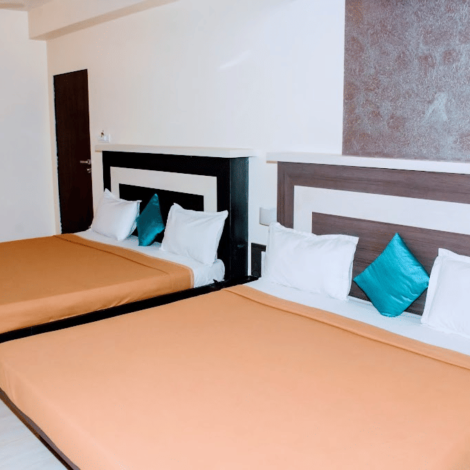 family room  with light gold bedding, a dark wardrobe, decorative ceiling wood panels, and an extra bed.