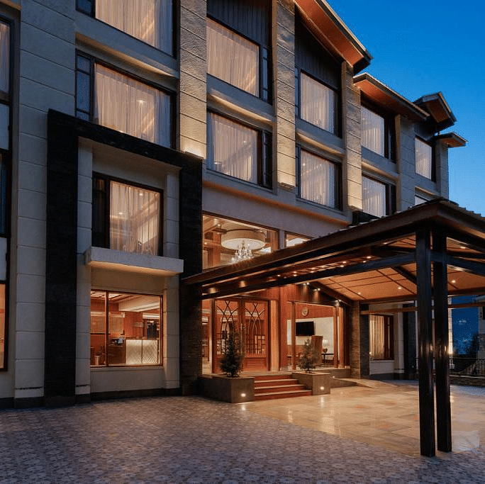 Entrance of The Orchid Hotel Manali with large windows