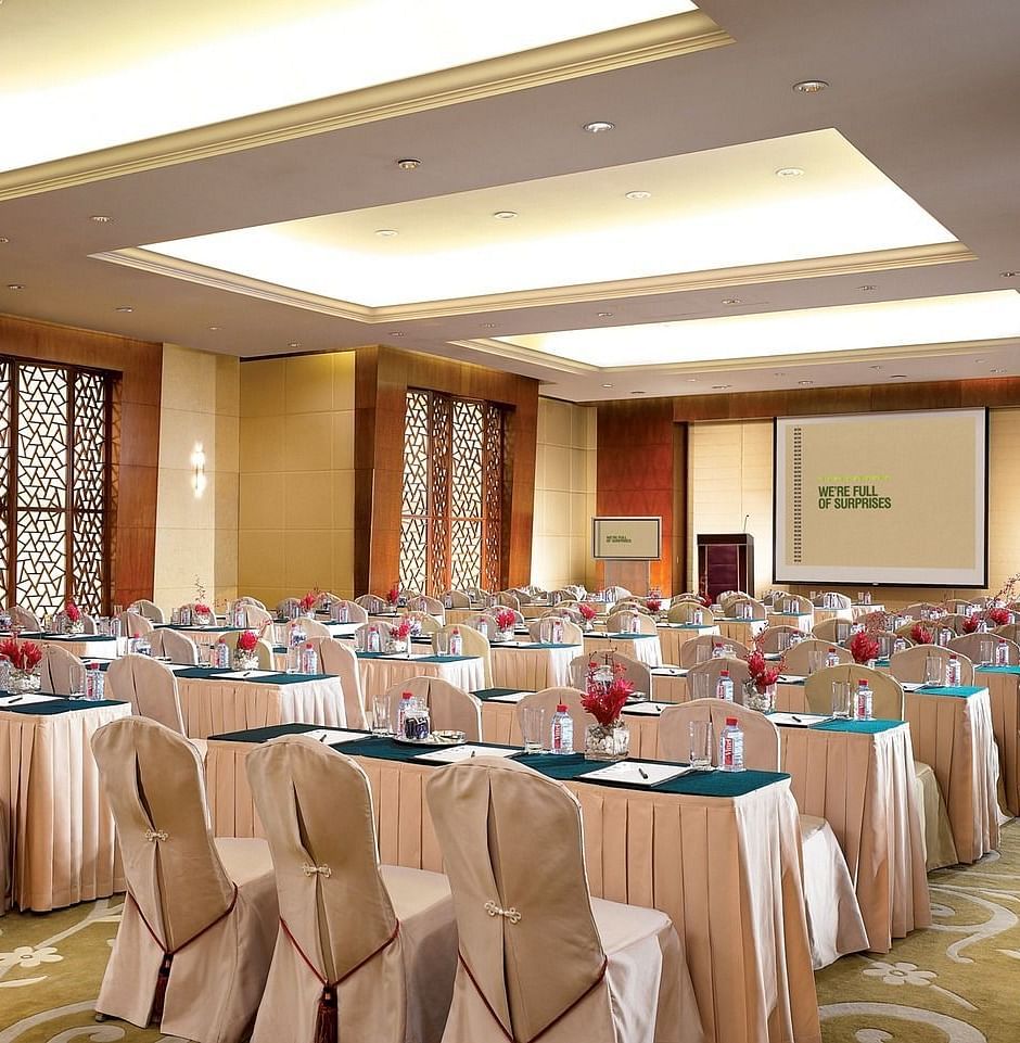 Image of a banquet all arranged for some event with blue and white chairs and tables.