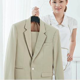 image of a woman holding a beige coat