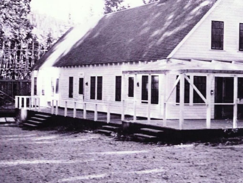 A black and white image of the exterior of Shaver Lake Village Hotel.
