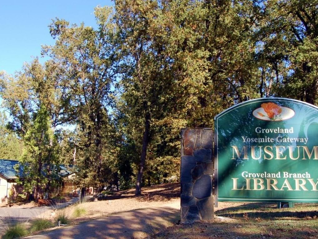 A sign reading Groveland Yosemite Gateway Museum and Groveland Branch Library - The Groveland Hotel.
