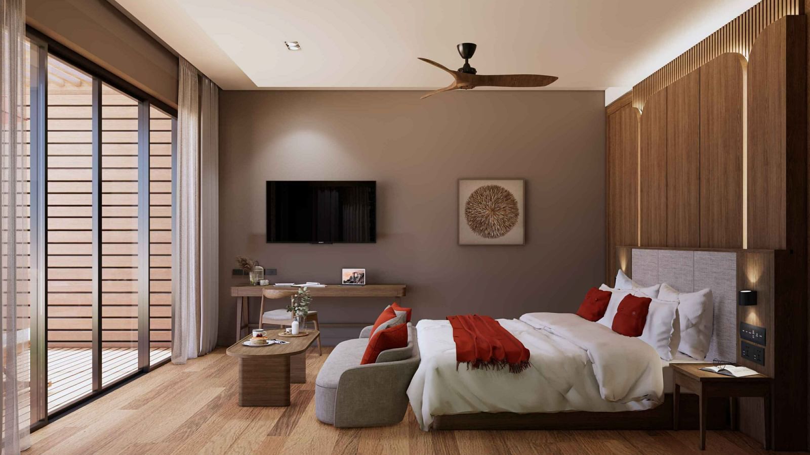 A bedroom featuring a large bed with red pillows, wooden interiors, mounted flat-screen TV, work desk, and sliding glass doors at Ramada Resort by Wyndham Khao Lak.