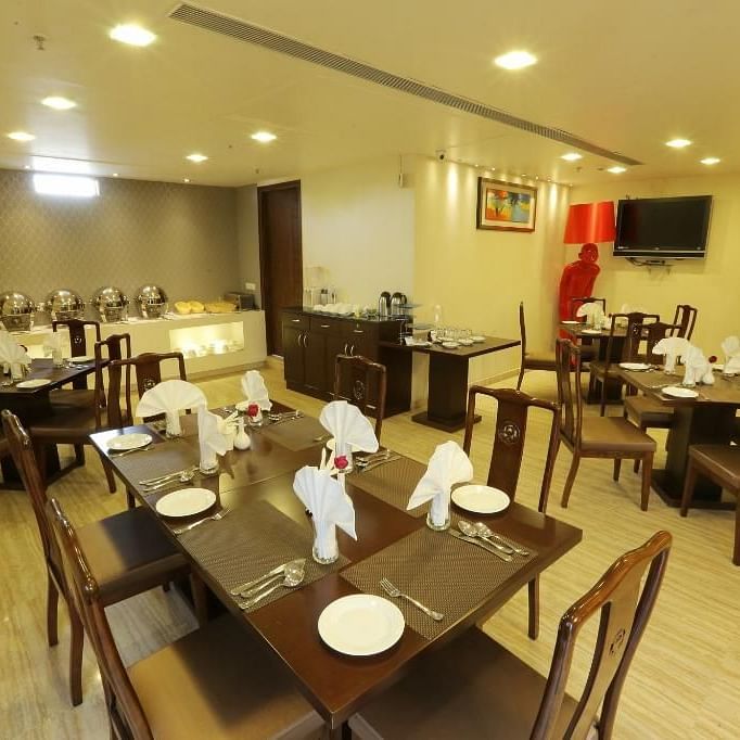 A restaurant with several tables and chairs - Five Elements Hotels