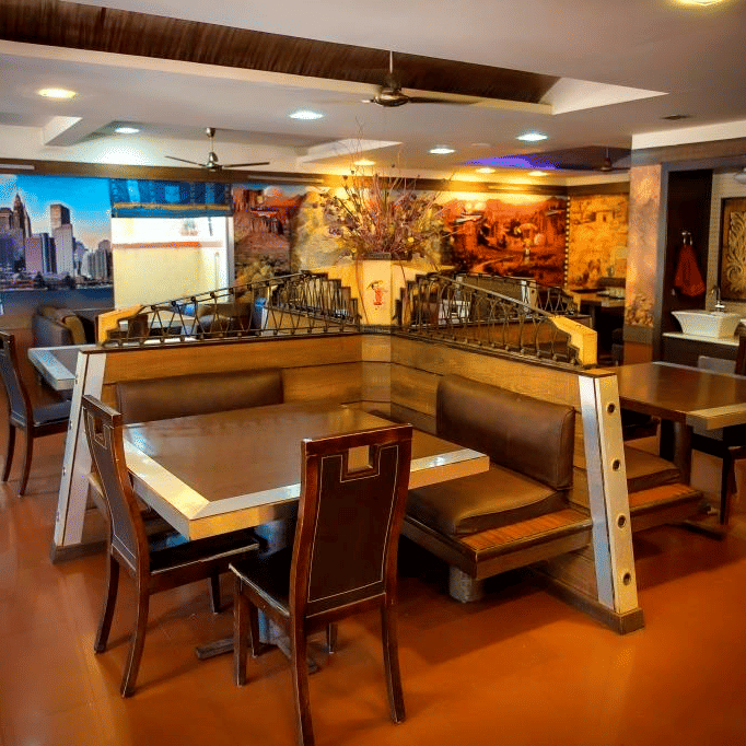 Picture of aroma resturant, featuring tables and chairs set for dining