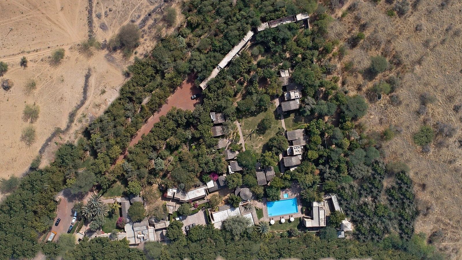 An aerial shot of the MANVAR Resort & Desert Camp surrounded with green trees