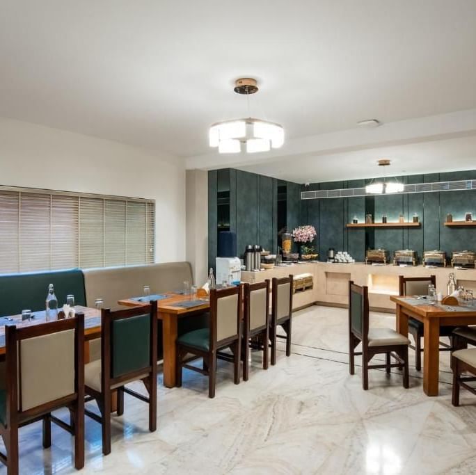 Modern dining space with wooden chairs and counters at Royal Group of Hotels