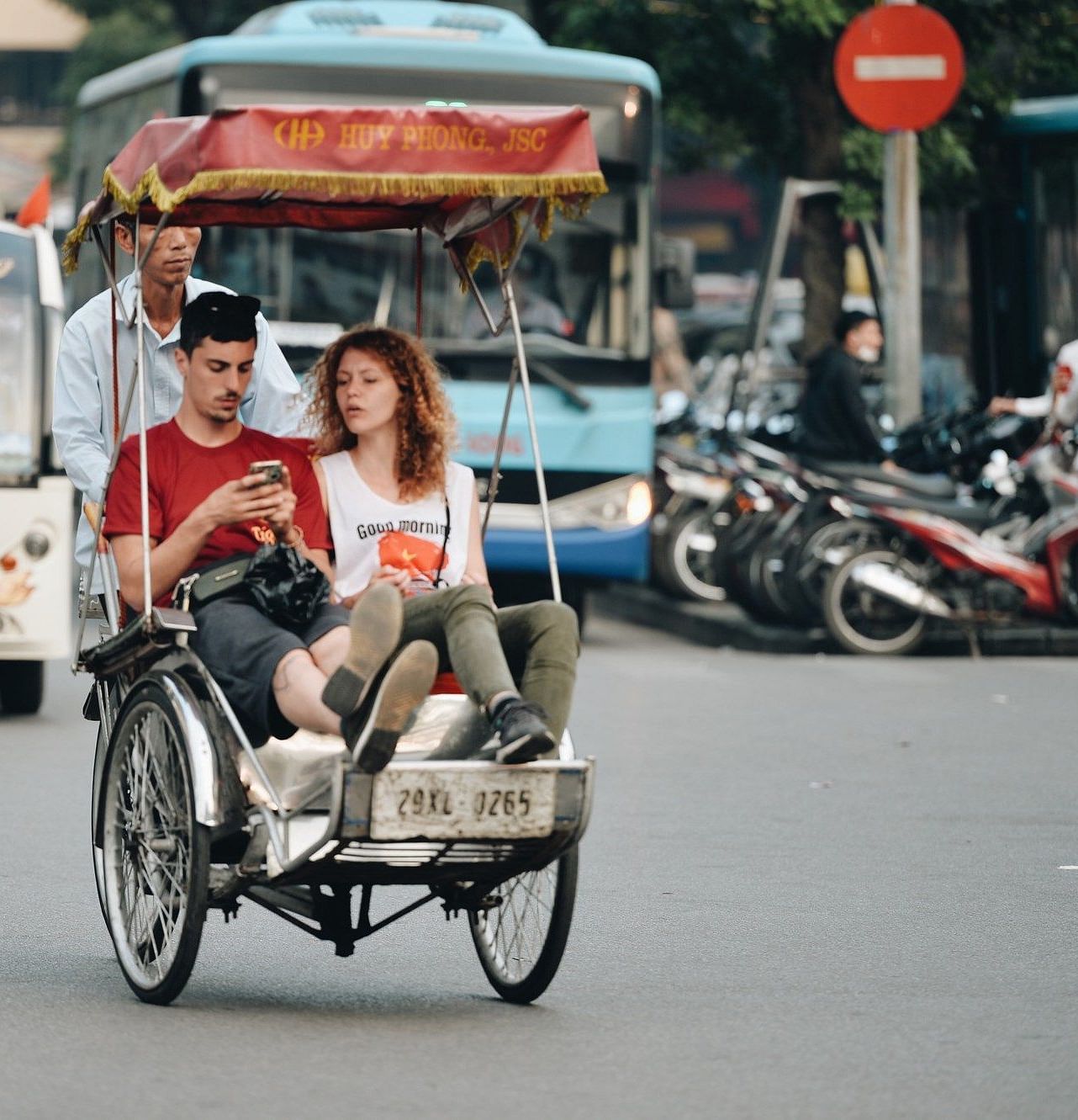 An image of two people sitting at a rickshaw - Alibu Resort Nha Thrang