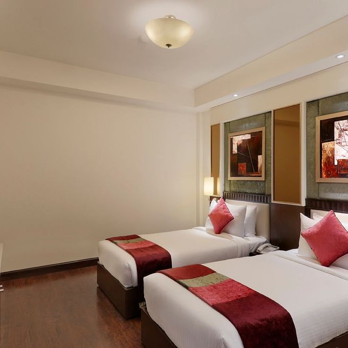 view of twin bed in Premium twin room of Inde Hotel Vista Woods, Gurgaon 