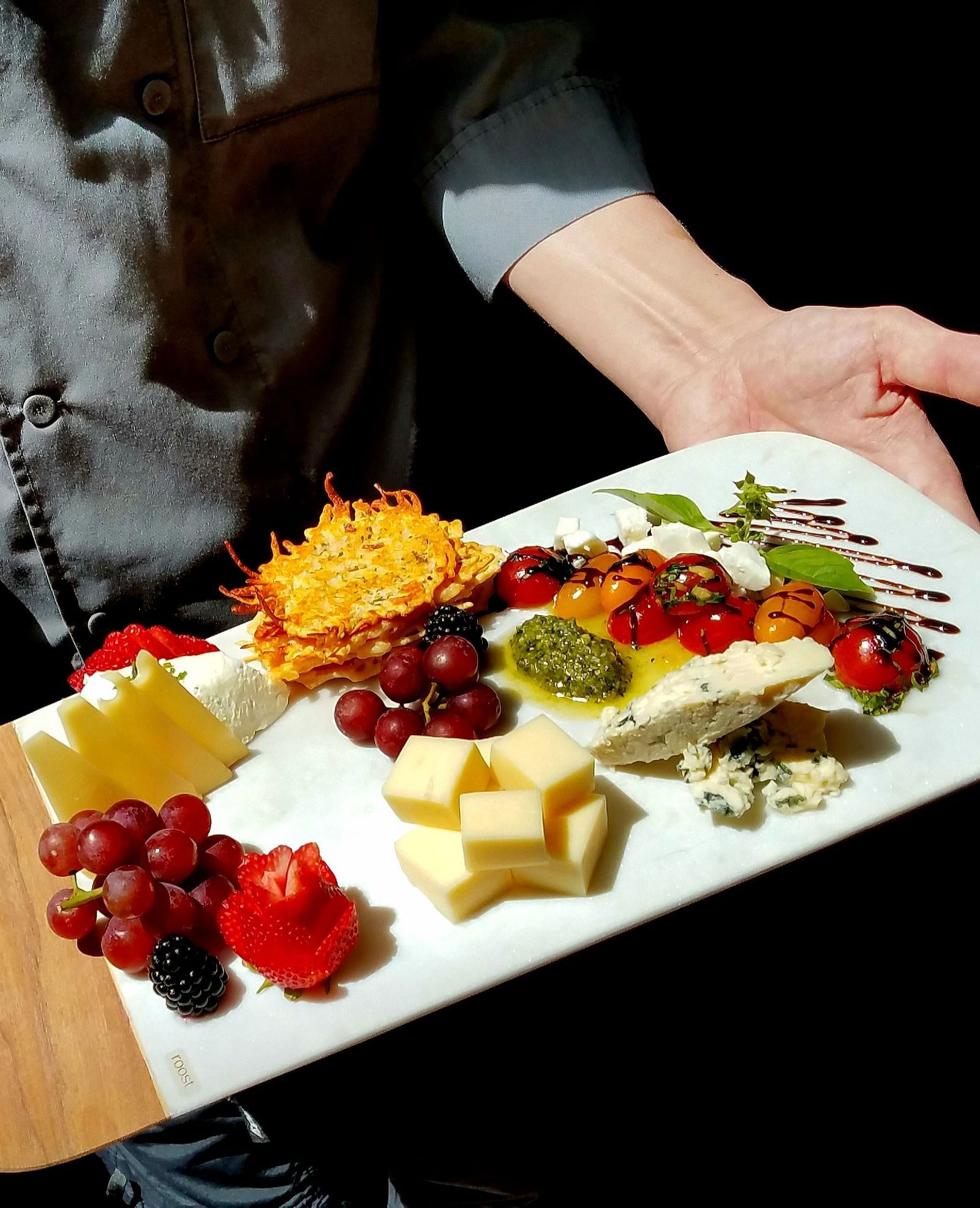 A chef presenting a beautifully plated dish with care - Brewery Gulch Inn & Spa